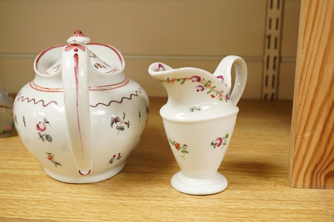 A Newhall porcelain boat shaped teapot, c.1800, together with a cream jug, tallest 14cm